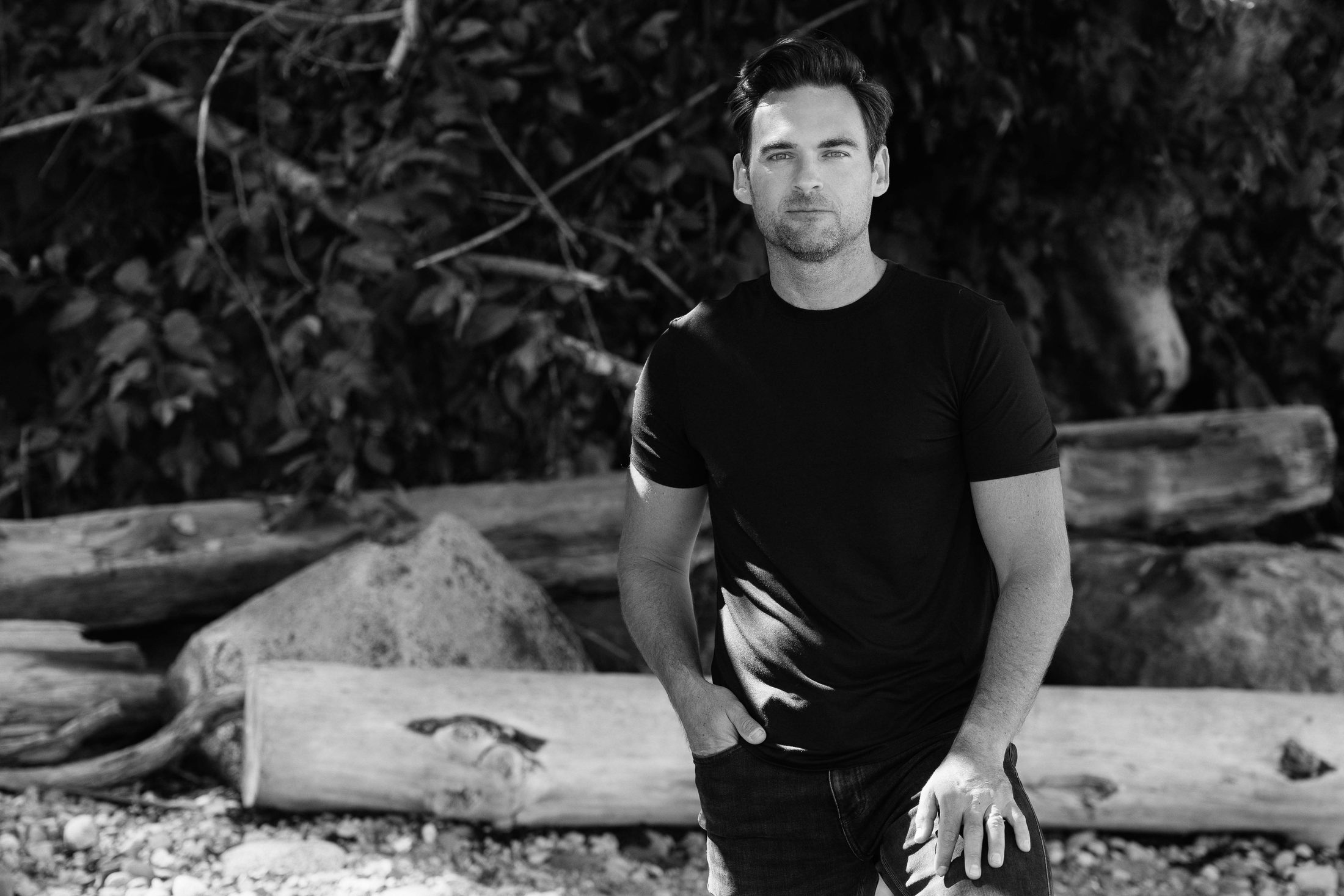 Joshua Matettore, standing outdoors, neutral expression.